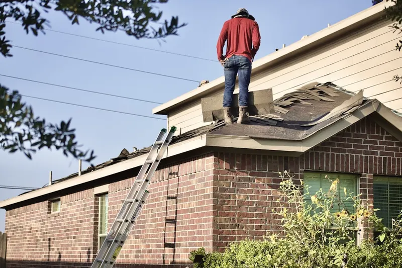 Professional roofer working on a residential roof in Eagleville